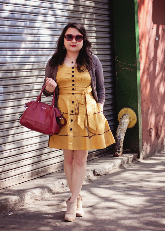 fashion blogger in a vintage inspired eshakti yellow sailboat dress and ankle boots