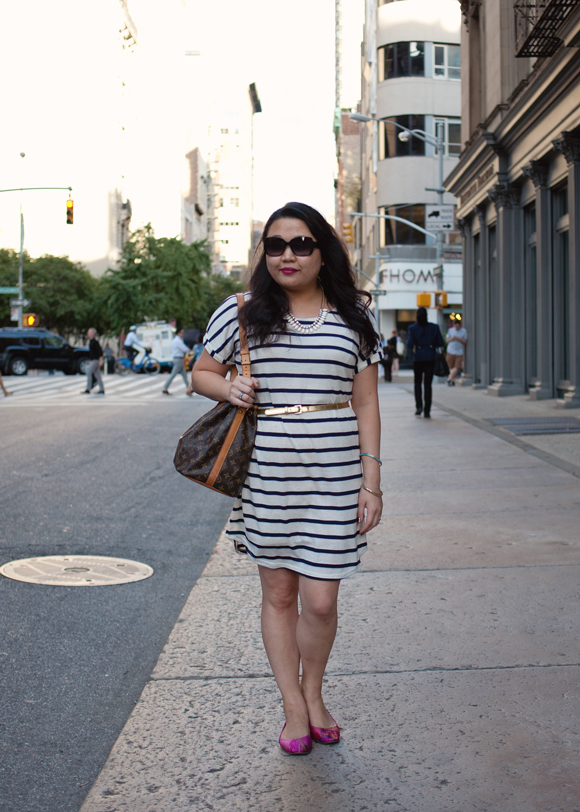 striped dress and louis vuitton petit noe bucket bag standing on the street in flatiron