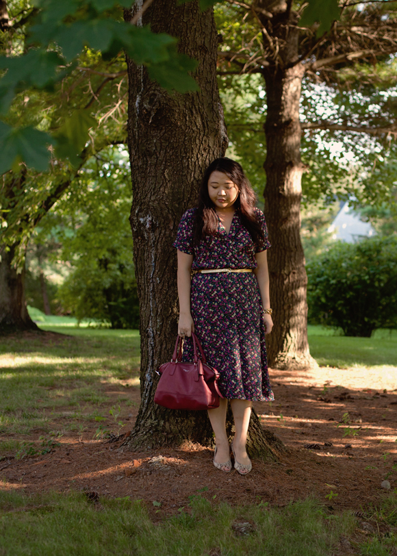 standing under a tree in a 90s vintage floral dress