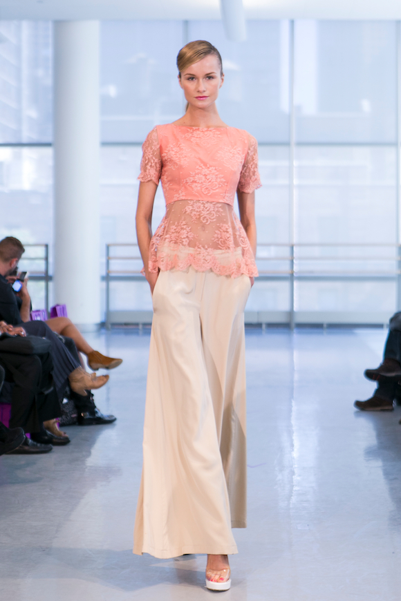 a model in a vintage inspired outfit with wide leg pants walks for yuna yang ss 2014. photo by charles roussel