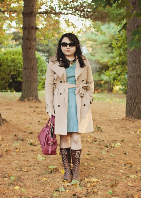 fashion blogger wearing a club monaco trench coat tied at the waist over a reiss dress