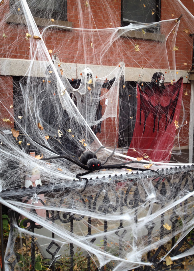 spider, web and ghouls decorating a house