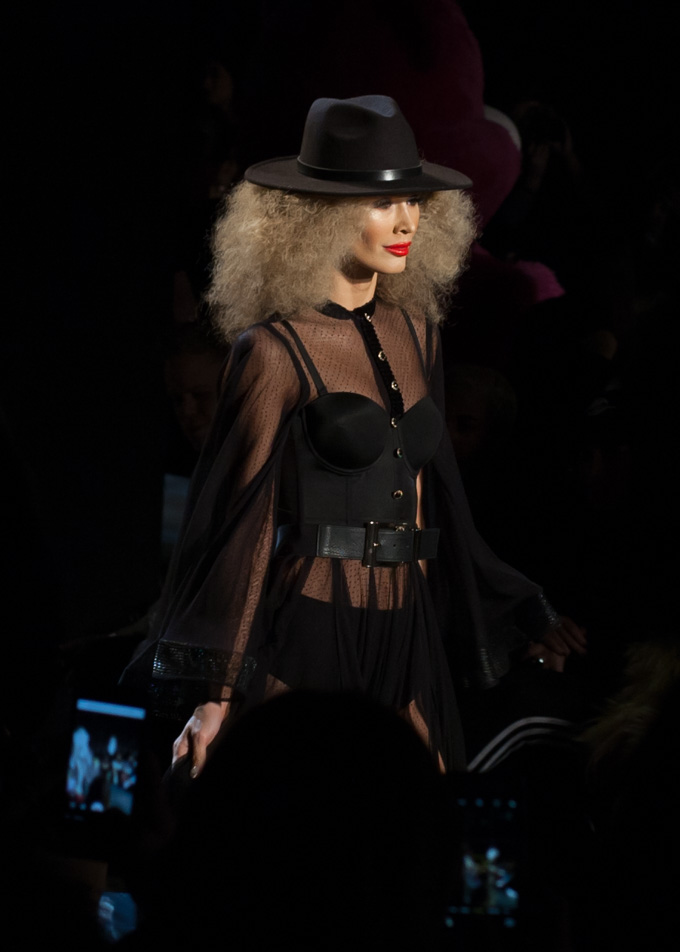 Photo of a model in a head-to-toe black outfit on the runway at Michael Costello Fall 2017. 
