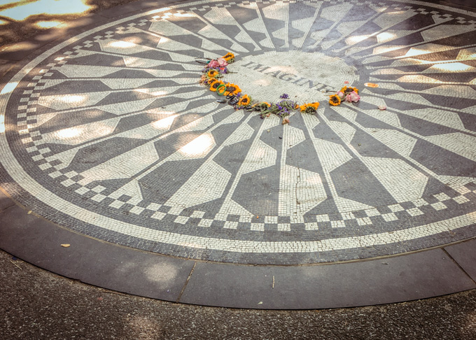 The Imagine mosaic memorial with flowers in Strawberry Fields, Central Park