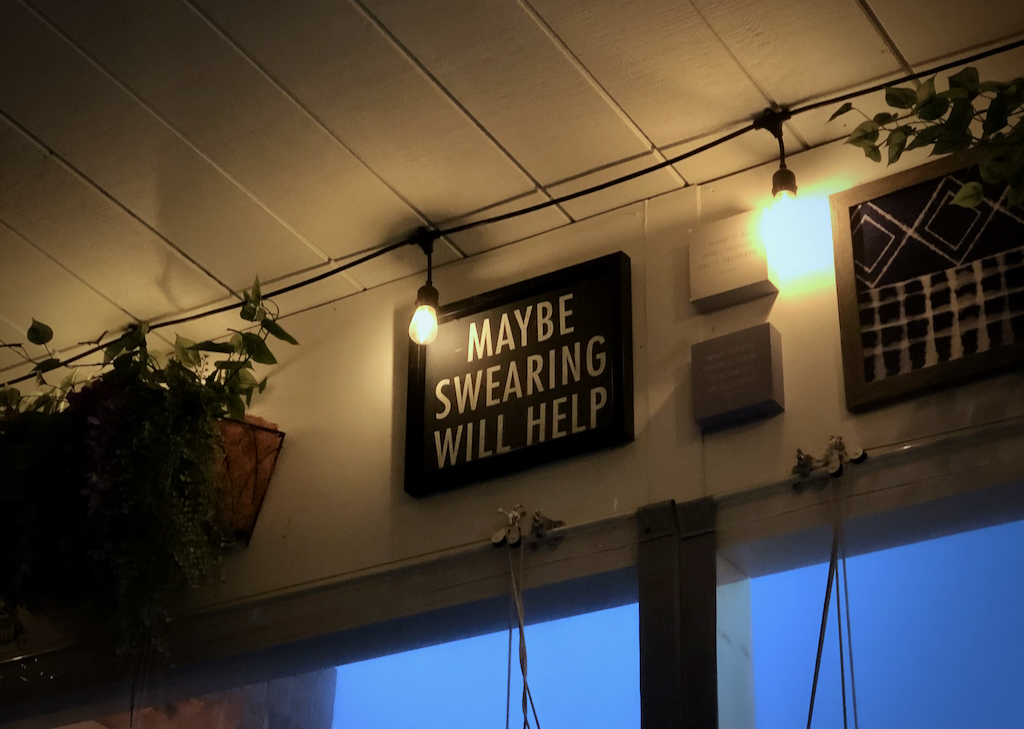 sign at a restaurant saying 'maybe swearing will help'
